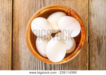 Fresh White Raw Chicken Eggs With Parsley On An Old Wooden Table