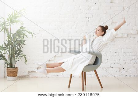 Studio Photo Of Young Good-looking European Caucasian Female Pictured In Bright White Room Dressed I