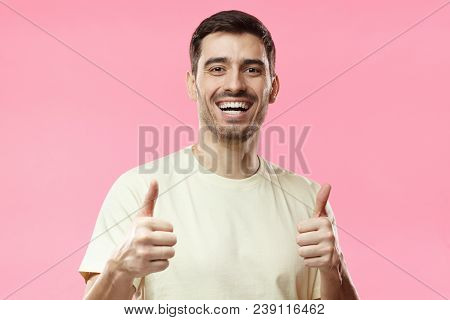 Indoor Picture Of Young European Male Isolated On Pink Background Wearing Casual T-shirt Smiling Hap