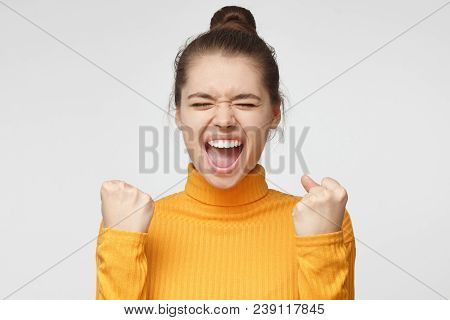 Closeup Photo Of Young Pretty European Female Isolated On Grey Background Dressed In Mustard Turtlen