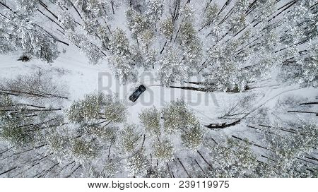Aerial View On Suv 6x6 That Rides By Winter Road In Snow-covered Forest.