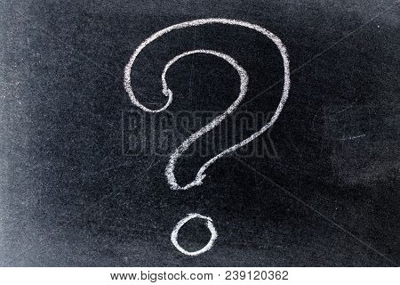 White Chalk Drawing In Questionmark Shape On Black Board Background