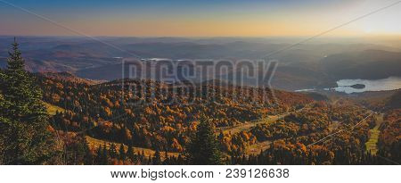 Aerial View Of Beautiful Lake Tremblant On A Sunny Day With Colorful Autumn Foliage Covering The Mou