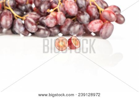 Red Globe Grape Cluster And One Fresh Shiny Dark Pink Berry Cut In Half Isolated On White Background