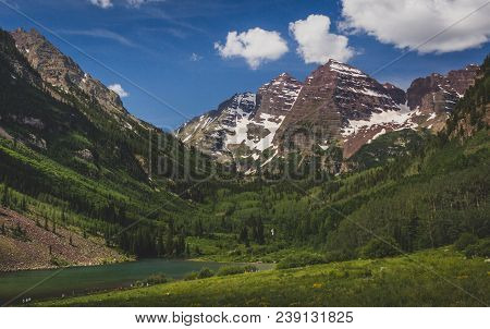 Majestic Maroon Bells Peaks And Maroon Lake On A Sunny Day And Blue Sky In Summer Near Aspen, Colora