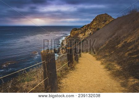 Coastal Hiking Trail Cascading Down The Steep Cliffs Of Pelican Cove Park On A Cloudy Day With Beams