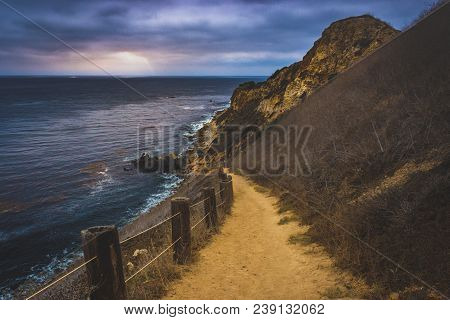 Coastal Hiking Trail Cascading Down The Steep Cliffs Of Pelican Cove Park On A Cloudy Day With Beams