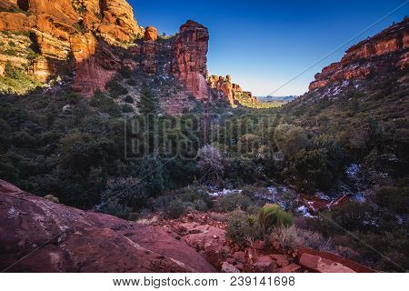 Stunning View Of Fay Canyon From Above The Treetops With Patches Of Snow On The Ground And Majestic 