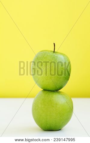 Green Ripe Apple On The Apple On The Yellow Background