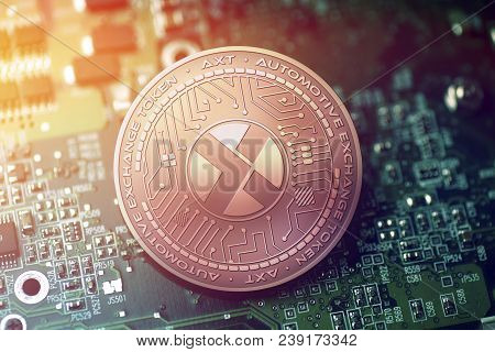 Shiny Copper Axt Cryptocurrency Coin On Blurry Motherboard Background Token