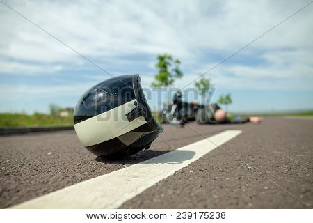 Biker Helmet Lies On Street Near A Motorcycle Accident