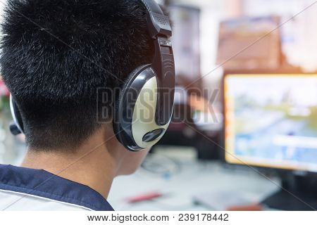 Education E-learning Foreign Languages Concept : Asian Student Young Man Wearing Headphones Listenin