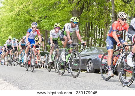 Vielsalm- Belgium, April 22, 2018: Cyclists Compete Riding Rapid And Pass The Nature Forest In Sunny
