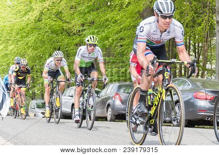 Vielsalm- Belgium, April 22, 2018: Cyclists Compete Riding Rapid And Pass The Nature Forest In Sunny
