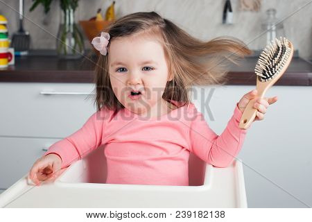 Girl 2 Years Playing With A Comb At Home - Learning To Comb Her Long Hair, Writhes Doing Funny And S