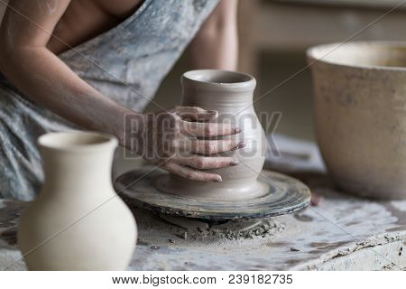 Potter Sculpts A Vase On A Potter's Wheel