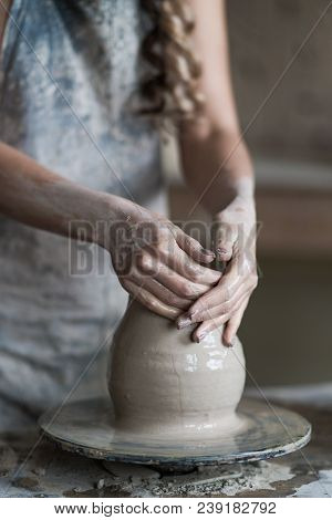 Potter Sculpts A Vase On A Potter's Wheel