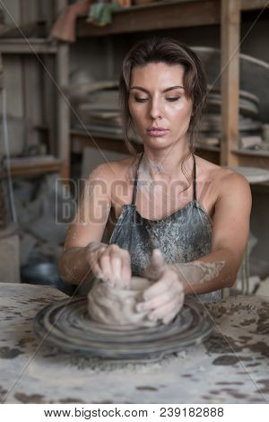 Potter Sculpts A Vase On A Potter's Wheel