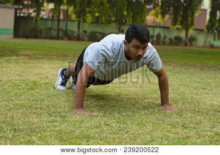 Young Guy Doing Push Ups In A Park