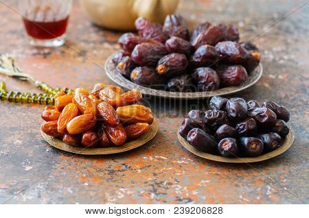Various Of Dried Dates Or Kurma In A Vintage Plates And Tea