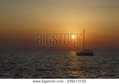 Ship Sailing At Sunset In Croatia, Crossing The Sun
