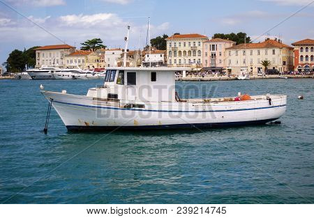 Small Fishing Boat In Mediterranean Harbor In Porec, Croatia