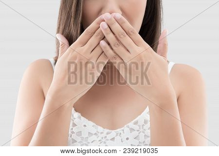 Asian Woman Use Both Hands Close Mouth For Not Commenting Or Refusing On Gray Background