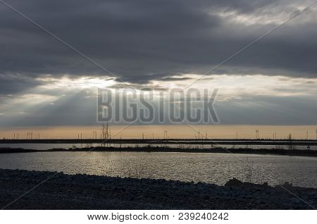 Late At Night. Sundown And Sunrises. River Running Across The Field With Reflections In The Water. E