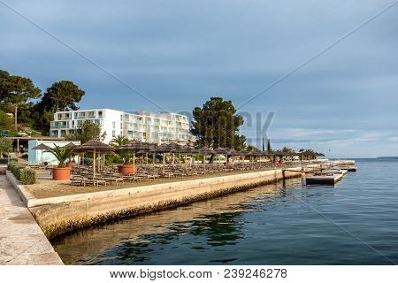 Beach With Beach Chairs In Morning Light On The Beach Of A Croatian Seaside Holiday Resort In Porec,