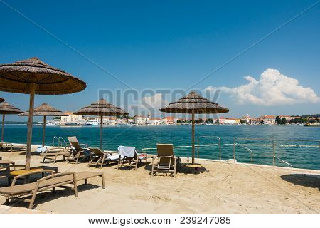 Beach With Beach Chairs In Morning Light On The Beach Of A Croatian Seaside Holiday Resort In Porec,