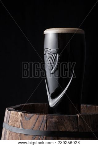 London, Uk - May 03, 2018: Original Glass Of Guinness Draught Stout Beer On Top Of  Wooden Barrel On