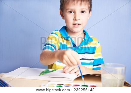 Cute Caucasian Boy Is Painting With Aquarelles.