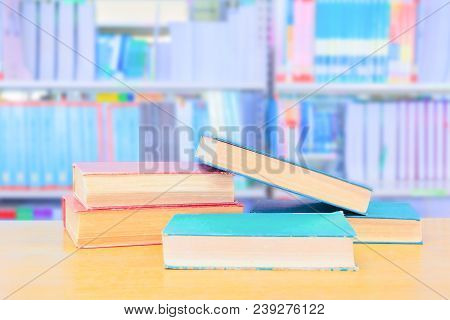 Old Book Red - Green. And Heap Treatise In School Library On Wooden Table.  Blurry Bookshelves Backg