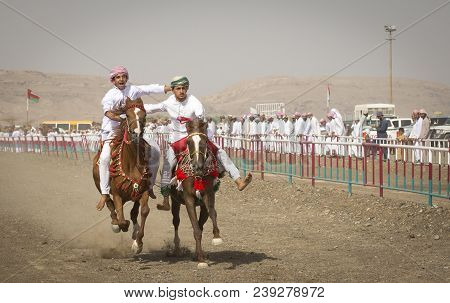 Ibri, Oman, 28th April 2018: Omani Men At A Traditional Horse Race Event Where Young Riders Show The