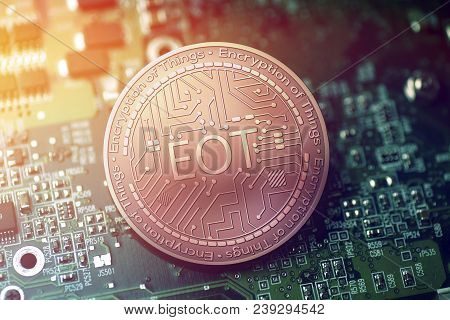 Shiny Copper Eot Cryptocurrency Coin On Blurry Motherboard Background Token