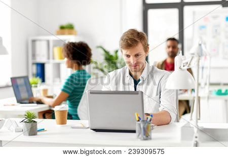 business and creative people concept - male office worker with laptop computer networking