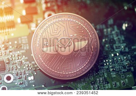 Shiny Copper Gnosis Cryptocurrency Coin On Blurry Motherboard Background Token