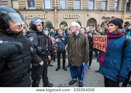 ST.PETERSBURG, RUSSIA - MAY 5, 2018: Police officers in riot gear block an Nevsky prospect during an opposition protest rally ahead of V.Putin's inauguration ceremony (Inscription: to remove Putin)