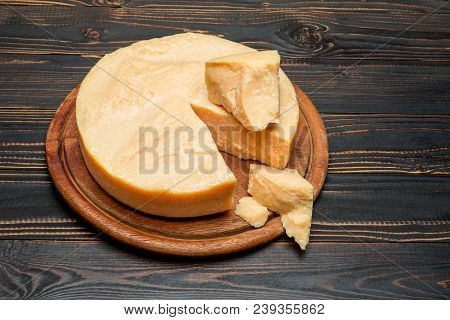 Whole Round Head And Pieces Of Parmesan Or Parmigiano Hard Cheese