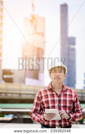 Asian Business And Engineer Man With Red Scott Shirt Has Planning And Working For Design Buiding And