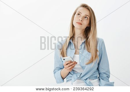 Girl Trying To Remember Date Of Appointment. Portrait Of Focused Thougtful Young Woman With Fair Hai
