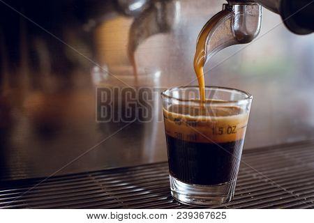 Professional Espresso Machine Pouring Strong Looking Fresh Coffee Into A Measure Glass Cup