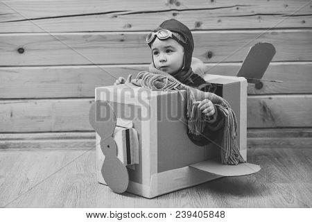 Little Child Boy In Pilot Costume Is Playing And Dreaming Of Becoming A Airman. Portrait Of Funny Ki