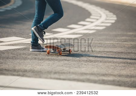 One Young Skateboarder Sakteboarding On Highway Road