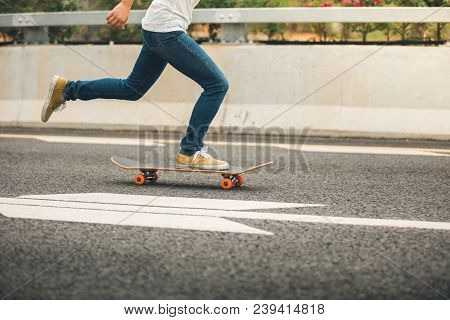 One Young Woman Skateboarder Sakteboarding On Highway