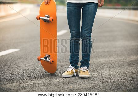 One Young Female  Skateboarder Sakteboarding On Highway