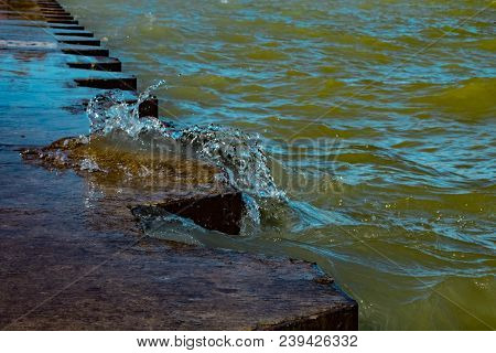Small Wave Comes Out From Lake Michigan On The Concrete Shore On Montrose Beach , Chicago Illinois A