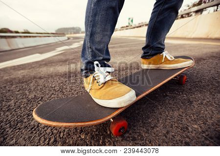 Closeup Of Skateboarder Sakteboarding On City Highway