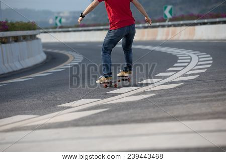 Closeup Of Skateboarder Sakteboarding On City Highway