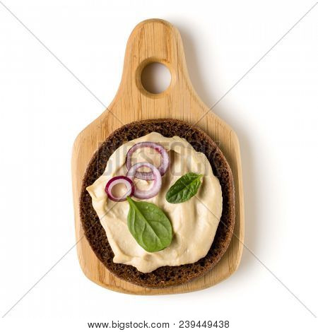 Open  faced hummus sandwich canape or crostini on a wooden serving board  isolated on white background closeup. Top view. Vegetarian tartarine.
